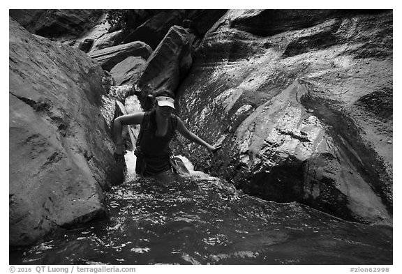 Woman walking in stream, Orderville Canyon. Zion National Park (black and white)