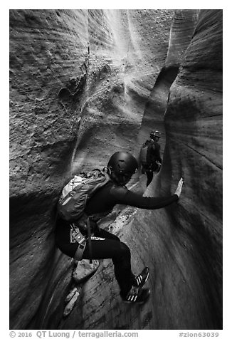 Canyoneer using chimney technique in narrow section of Keyhole Canyon. Zion National Park (black and white)