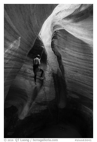 Canyoneer rappels into Keyhole Canyon. Zion National Park (black and white)