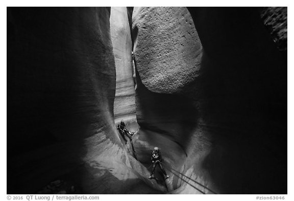 Canyoneers deep in subterranean part of Keyhole Canyon. Zion National Park (black and white)
