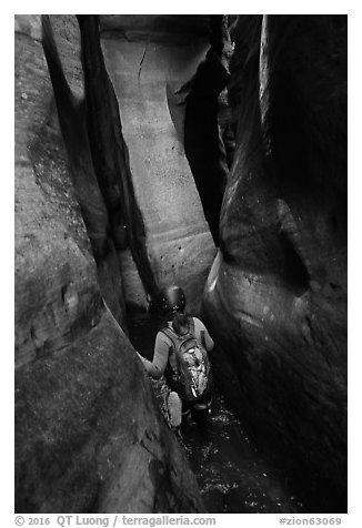 Canyoneer in tight squeeze, Das Boot Canyon. Zion National Park (black and white)