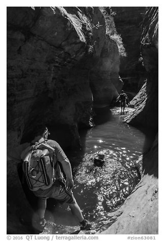Hikers swim across pool, Left Fork. Zion National Park (black and white)