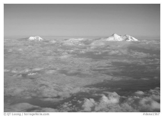 Summit of Mt Foraker and Mt Mc Kinley emerging from  clouds. Denali National Park, Alaska, USA.