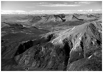 Aerial view of mountains with meandering Alatna river in the distance. Gates of the Arctic National Park, Alaska, USA. (black and white)