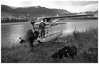 Backpackers beeing dropped off by a floatplane at Circle Lake. Gates of the Arctic National Park, Alaska (black and white)