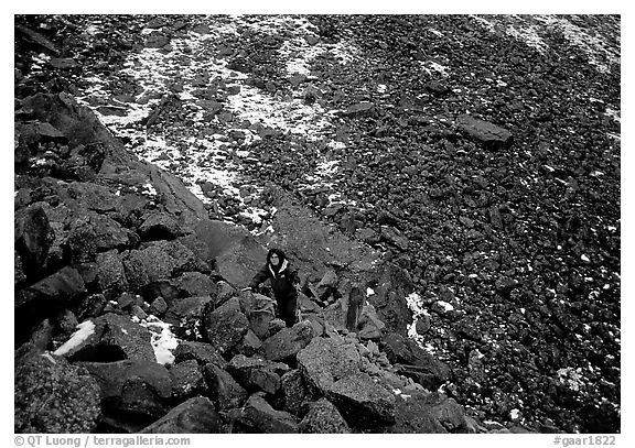Backpacker in boulder field at the base of the Arrigetch Peaks. Gates of the Arctic National Park, Alaska