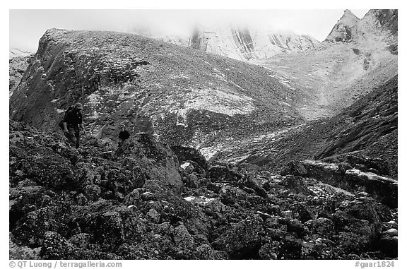 Backpackers on boulder fields in Aquarius Valley. Gates of the Arctic National Park, Alaska