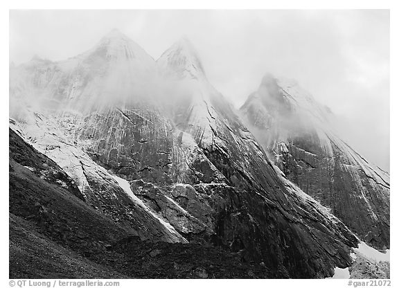 The Maidens with fresh show and a thin veil of clouds. Gates of the Arctic National Park, Alaska, USA.