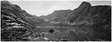 Mineral landscape with scree, rocky peaks, and lake. Gates of the Arctic National Park (Panoramic black and white)