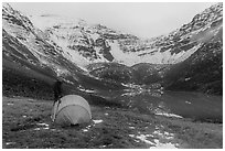 Camper standing by tent near  Lake and Three River Mountain. Gates of the Arctic National Park ( black and white)