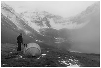 Camper standing by tent with fog approaching. Gates of the Arctic National Park ( black and white)