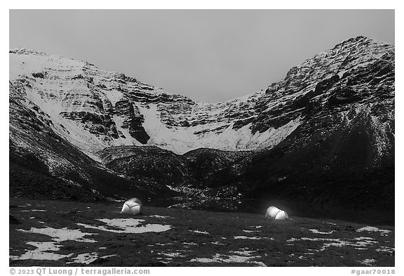 Lighted tents at night and Three River Mountain. Gates of the Arctic National Park (black and white)