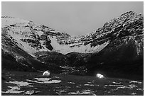 Lighted tents at night and Three River Mountain. Gates of the Arctic National Park ( black and white)