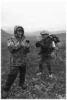 Nunamiut man and visiting backpacker with cell phones. Gates of the Arctic National Park ( black and white)