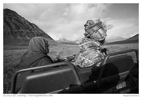 Nunamiut family on all-terrain vehicle from the back. Gates of the Arctic National Park (black and white)