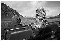 Nunamiut family on all-terrain vehicle from the back. Gates of the Arctic National Park ( black and white)