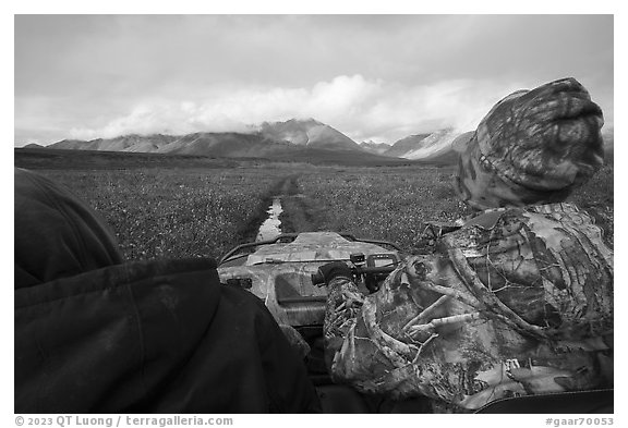 Nunamiut family on Argo following ATV trail. Gates of the Arctic National Park (black and white)