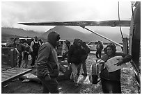 Unloading airplane, Anaktuvuk Pass Airport. Gates of the Arctic National Park ( black and white)