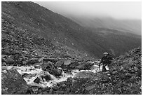 Hiker in rocky gorge, Three River Mountain. Gates of the Arctic National Park ( black and white)