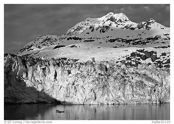 Face of Lamplugh Glacier illuminated by the sun on cloudy day. Glacier Bay National Park, Alaska, USA.