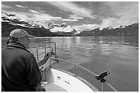 Man sitting at the bow of a small boat. Glacier Bay National Park, Alaska, USA. (black and white)