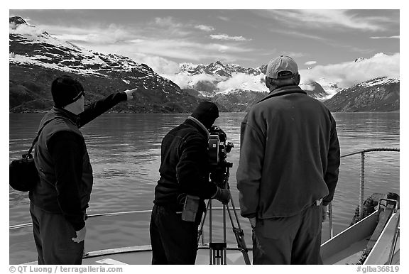 Crew filming from the deck of a boat. Glacier Bay National Park, Alaska, USA.