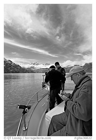 Movie producer taking notes as crew films. Glacier Bay National Park (black and white)