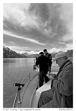 Movie producer taking notes as crew films. Glacier Bay National Park, Alaska, USA.