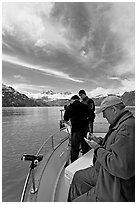 Movie producer taking notes as crew films. Glacier Bay National Park, Alaska, USA. (black and white)