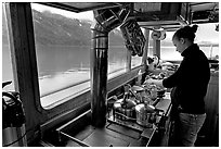 Chef preparing sadad in the main cabin of the Kahsteen. Glacier Bay National Park, Alaska, USA. (black and white)