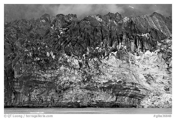 Ice colored by black moraining debris on the front of Margerie Glacier. Glacier Bay National Park, Alaska, USA.