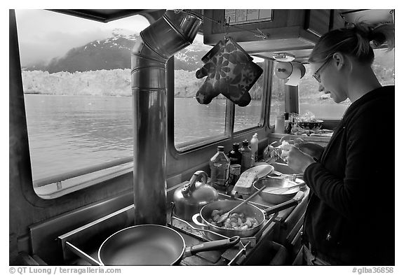 Woman preparing a breakfast aboard small tour boat. Glacier Bay National Park (black and white)