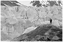 Hiker on a hill below Reid Glacier. Glacier Bay National Park, Alaska, USA. (black and white)
