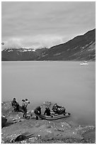 Film crew embarking on a skiff after shore excursion. Glacier Bay National Park, Alaska, USA. (black and white)