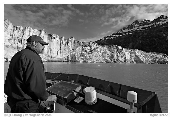 Captain guiding boat near Lamplugh glacier. Glacier Bay National Park (black and white)