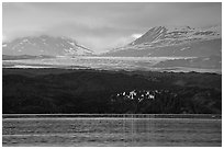 Last sunrays catched by the moraine-covered face of Grand Pacific Glacier. Glacier Bay National Park ( black and white)
