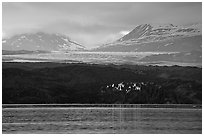 Last sunrays catched by the moraine-covered face of Grand Pacific Glacier. Glacier Bay National Park ( black and white)