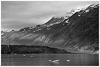 Slopes at the base of Mount Barnard illuminated by a late ray of sun. Glacier Bay National Park, Alaska, USA. (black and white)