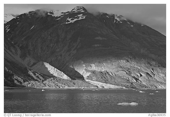 Sunset light falling on the base of the peaks around Tarr Inlet. Glacier Bay National Park, Alaska, USA.