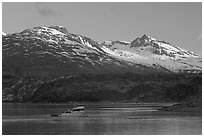 Small boat in Tarr Inlet, early morning. Glacier Bay National Park, Alaska, USA. (black and white)