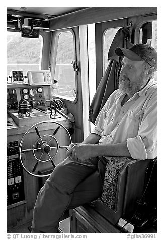 Captain sitting at the wheel. Glacier Bay National Park (black and white)