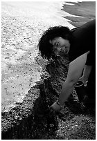 Backpacker collects water from a neve melt-off in the otherwise dry  Valley of Ten Thousand smokes. Katmai National Park, Alaska (black and white)