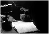 Backpacker writes into the log in USGS research cabins, Valley of Ten Thousand smokes. Katmai National Park, Alaska (black and white)