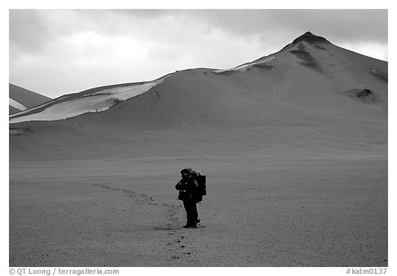 Backpacker leaves the Baked mountain behind, Valley of Ten Thousand smokes. Katmai National Park, Alaska