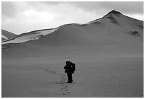 Backpacker leaves the Baked mountain behind, Valley of Ten Thousand smokes. Katmai National Park, Alaska (black and white)