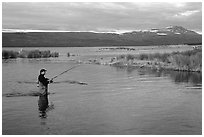 Man fishing for salmon in the Brooks river. Katmai National Park, Alaska, USA. (black and white)