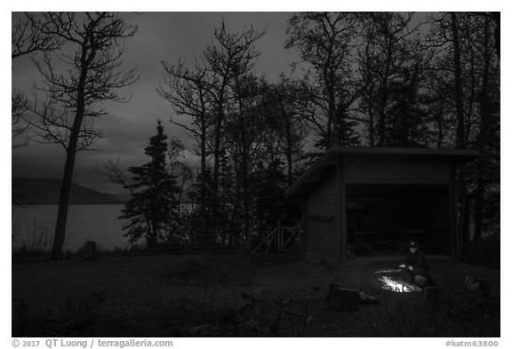 Camper sitting by campfire at night,  Brooks Camp. Katmai National Park (black and white)