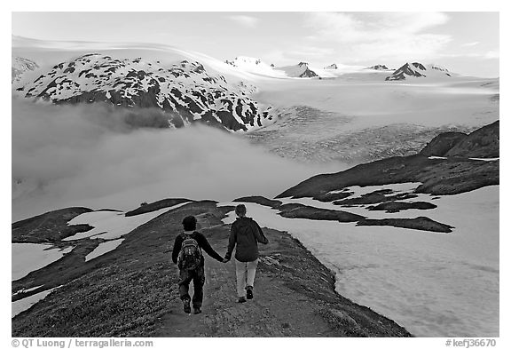 Couple hiking down Harding Icefied trail, late afternoon. Kenai Fjords National Park (black and white)