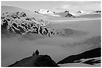 Two people hiking down Harding Ice Field trail. Kenai Fjords National Park, Alaska, USA. (black and white)