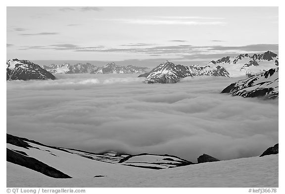 Peaks emerging from clouds at sunset. Kenai Fjords National Park, Alaska, USA.